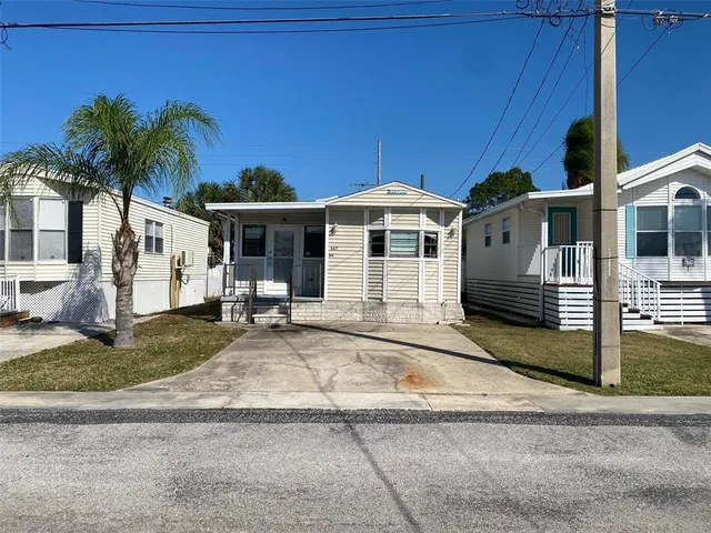 a front view of a house with porch and yard