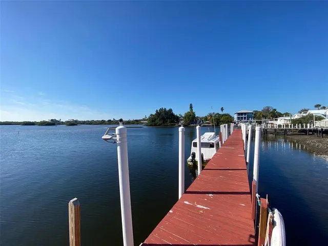 a view of a lake with boats in front of house