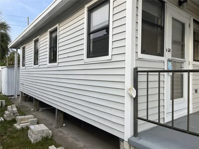 a view of a house with a door and a balcony