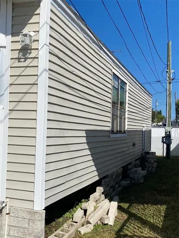 a view of a patio with chair and potted plants