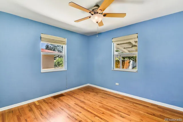 a view of a room with a window and ceiling fan
