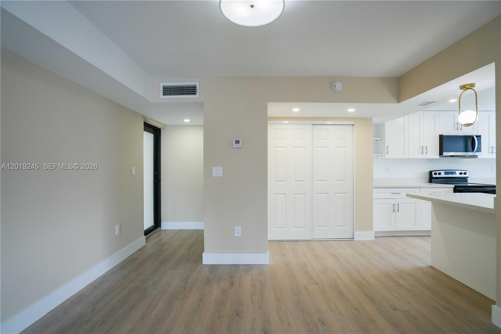 6960 Rue Vendome, Unit 201 Miami Beach, FL 33141 - Photo 6 of 27 a view of kitchen with stainless steel appliances granite countertop a refrigerator and a stove top oven