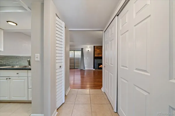 a view of an empty room with window and fireplace