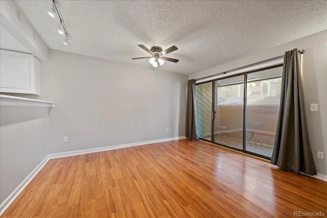 a view of a kitchen with wooden floor and a window