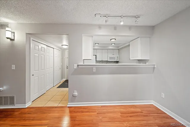 a kitchen with granite countertop a sink and cabinets