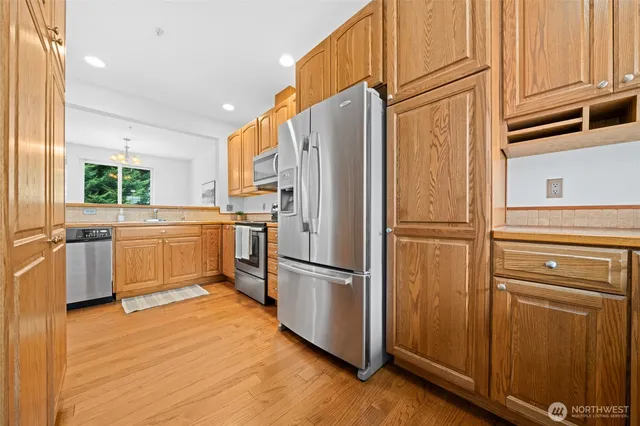 a kitchen with stainless steel appliances a refrigerator and a sink