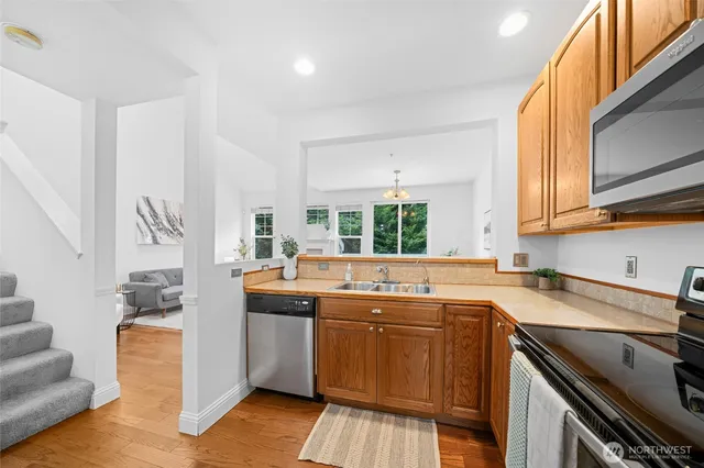 a kitchen that has a sink and a stove in it