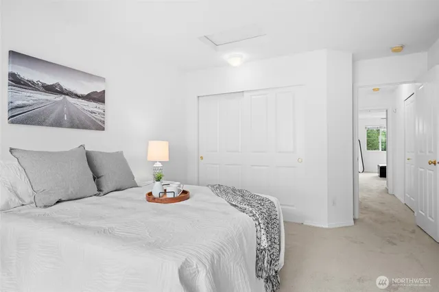 a bedroom with a bed and a painting on the wall