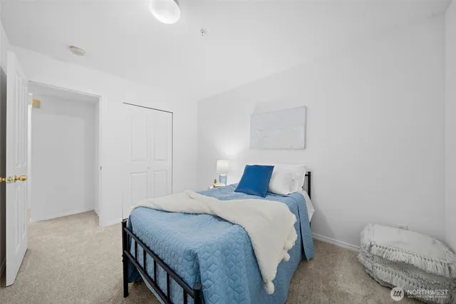 a bedroom with a bed and a mirror