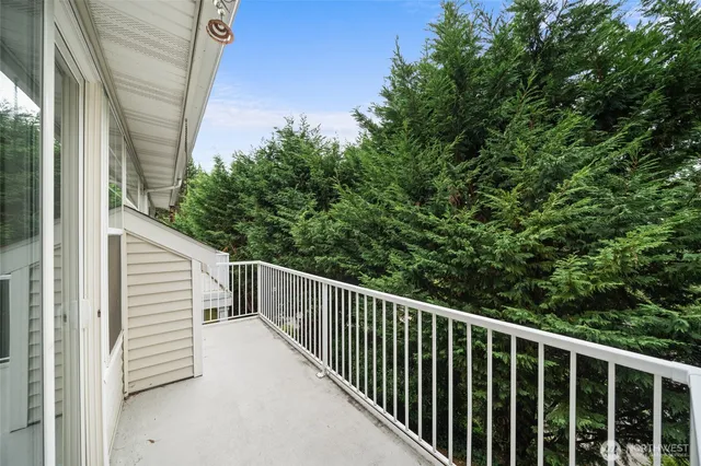 a view of a balcony with wooden fence and floor