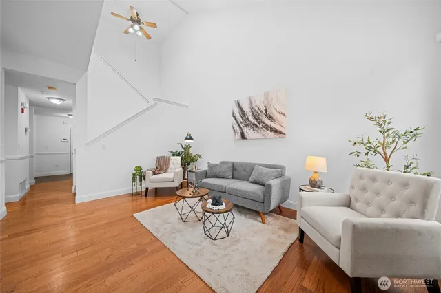 a living room with furniture and wooden floor