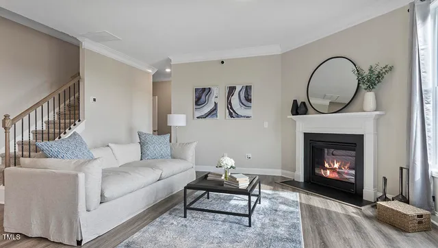 a living room with furniture a rug and a fireplace