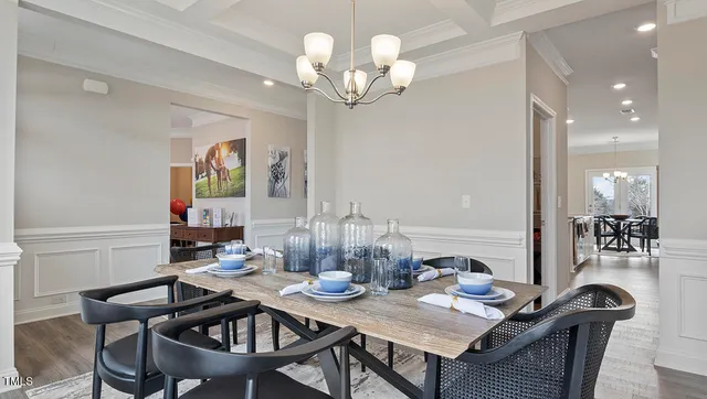a view of a dining room with furniture and chandelier