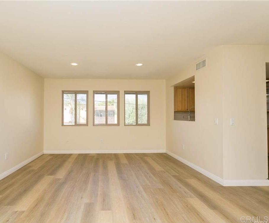 1069 Estes Street El Cajon, CA 92020 - Photo 11 of 41 a view of an empty room with wooden floor and a window