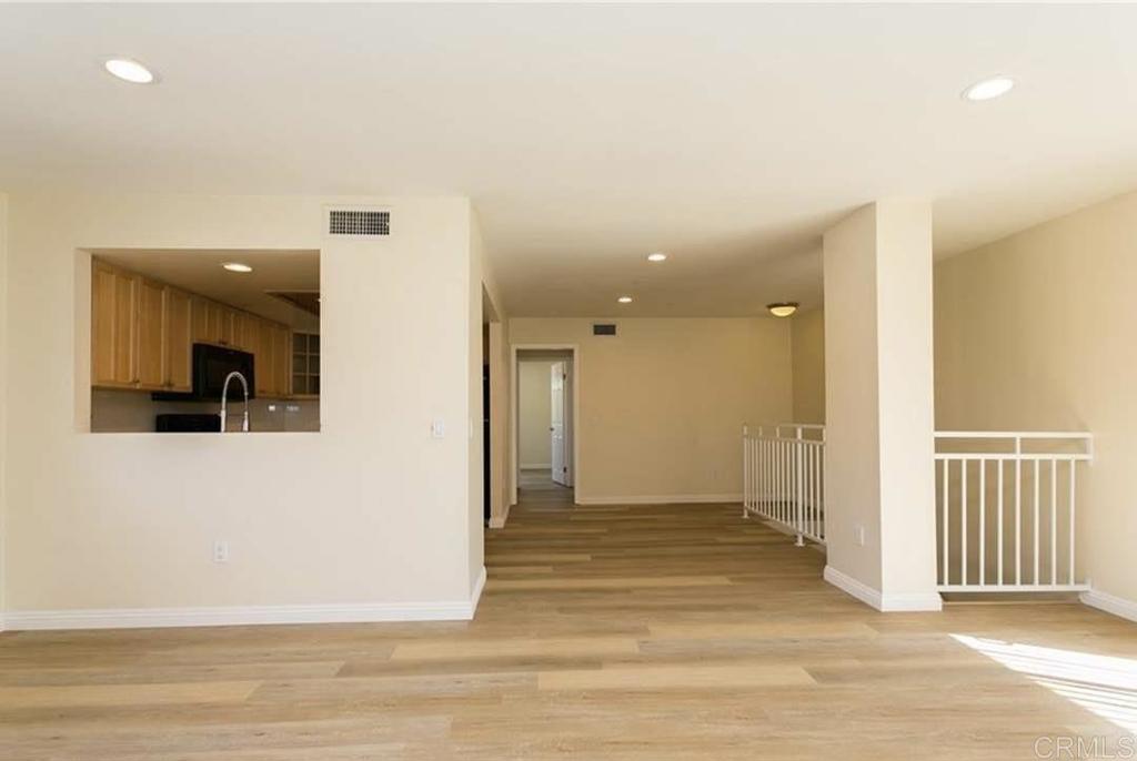 1069 Estes Street El Cajon, CA 92020 - Photo 12 of 41 a view of a hallway with wooden floor and a living room