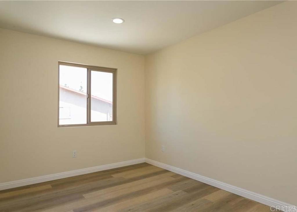 1069 Estes Street El Cajon, CA 92020 - Photo 15 of 41 an empty room with wooden floor and windows