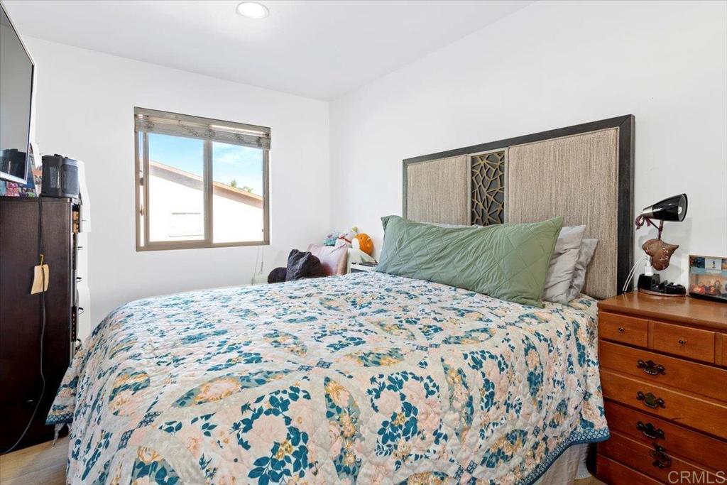 1069 Estes Street El Cajon, CA 92020 - Photo 19 of 35 a bedroom with a bed and dresser with mirror
