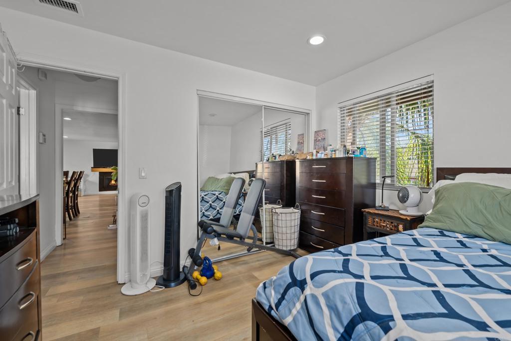 1069 Estes Street El Cajon, CA 92020 - Photo 23 of 41 a bedroom with a bed and wooden floor