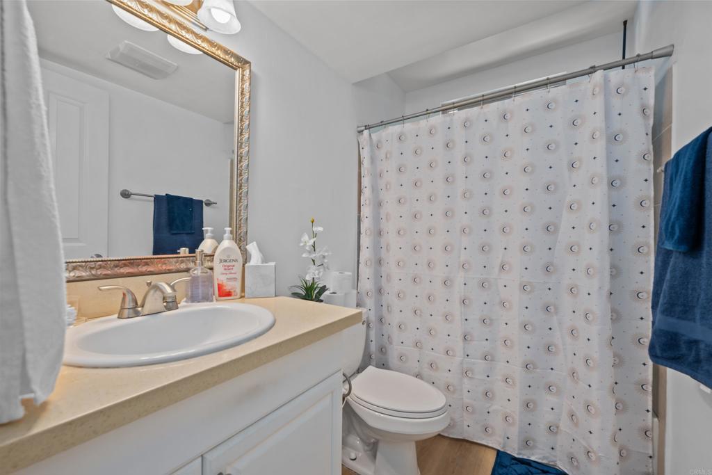 1069 Estes Street El Cajon, CA 92020 - Photo 25 of 41 a bathroom with a sink toilet and mirror