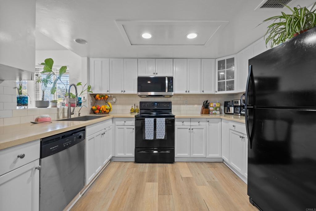 1069 Estes Street El Cajon, CA 92020 - Photo 26 of 41 a kitchen with granite countertop a refrigerator stove top oven and sink