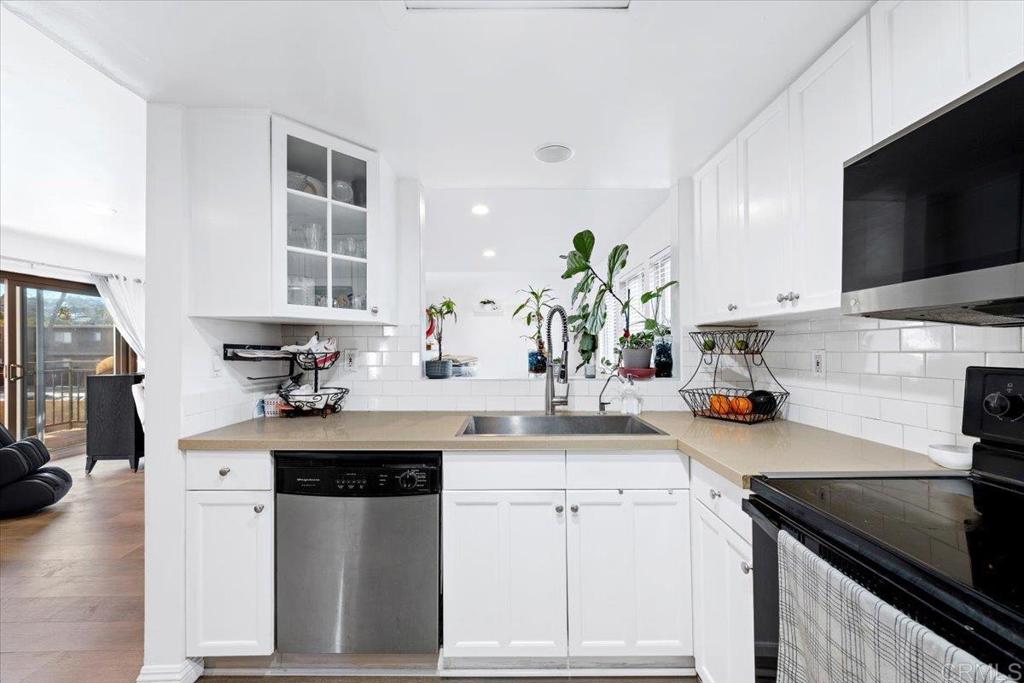 1069 Estes Street El Cajon, CA 92020 - Photo 28 of 35 a kitchen with stainless steel appliances kitchen island granite countertop a sink stove and cabinets
