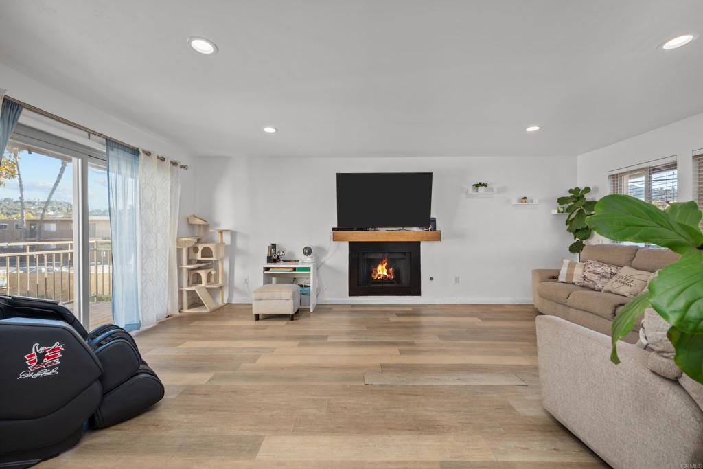 1069 Estes Street El Cajon, CA 92020 - Photo 28 of 41 a living room with furniture a fireplace and a flat screen tv
