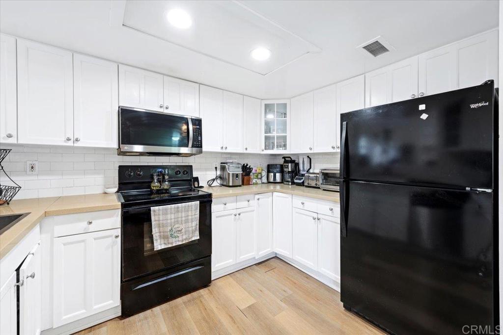 1069 Estes Street El Cajon, CA 92020 - Photo 29 of 35 a kitchen with a refrigerator stove and microwave