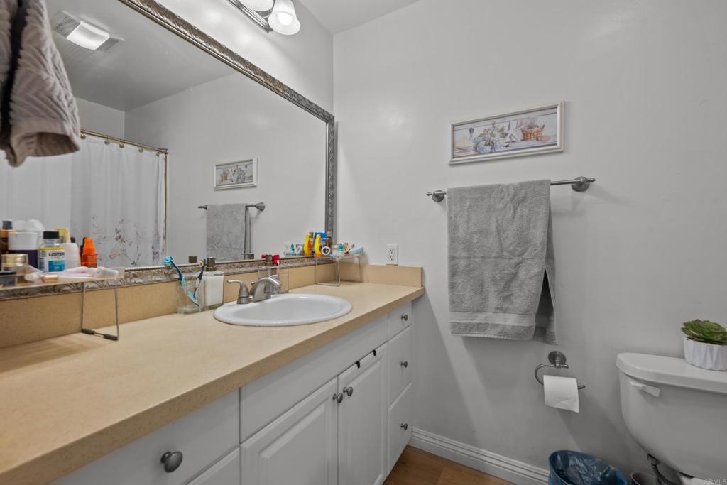 1069 Estes Street El Cajon, CA 92020 - Photo 29 of 41 a bathroom with a double vanity sink toilet and a mirror