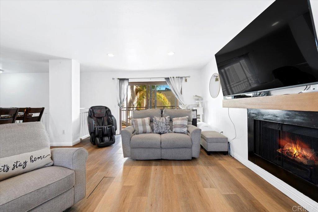 1069 Estes Street El Cajon, CA 92020 - Photo 33 of 35 a living room with furniture a flat screen tv and a fireplace