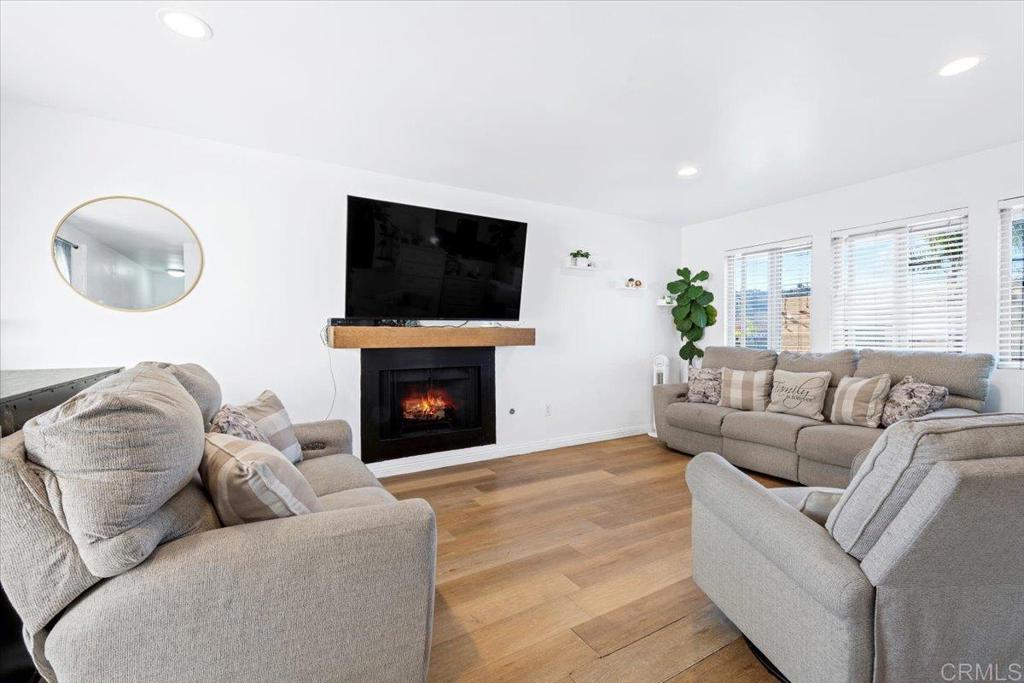 1069 Estes Street El Cajon, CA 92020 - Photo 34 of 35 a living room with furniture a fireplace and a flat screen tv