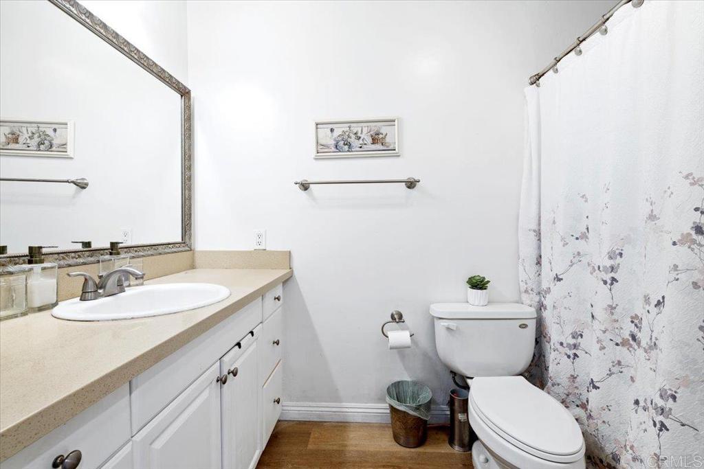 1069 Estes Street El Cajon, CA 92020 - Photo 35 of 35 a bathroom with a granite countertop toilet sink and mirror