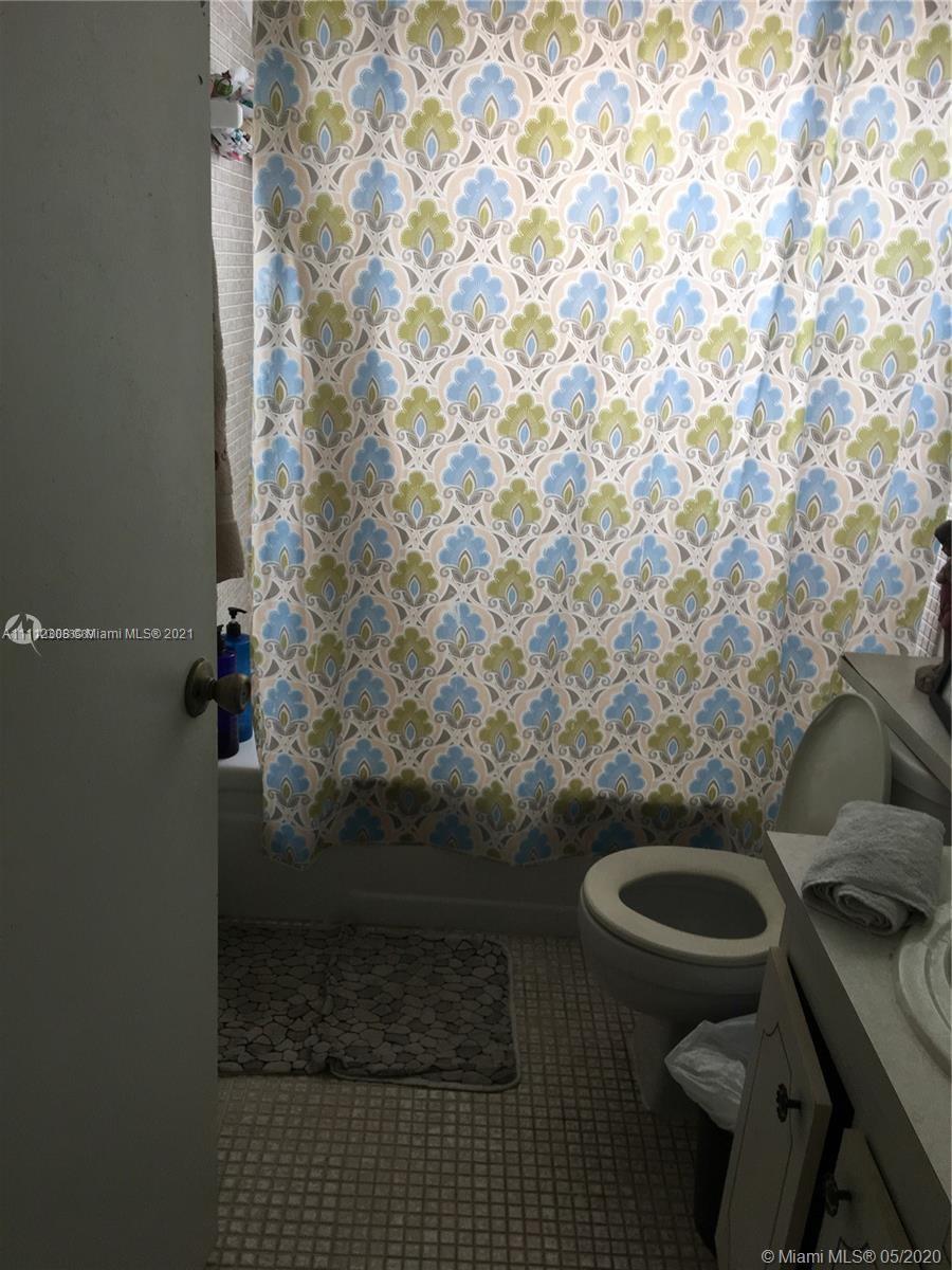 252 Fanshaw F, Unit 252F Boca Raton, FL 33434 - Photo 3 of 8 a bathroom with a toilet and a shower