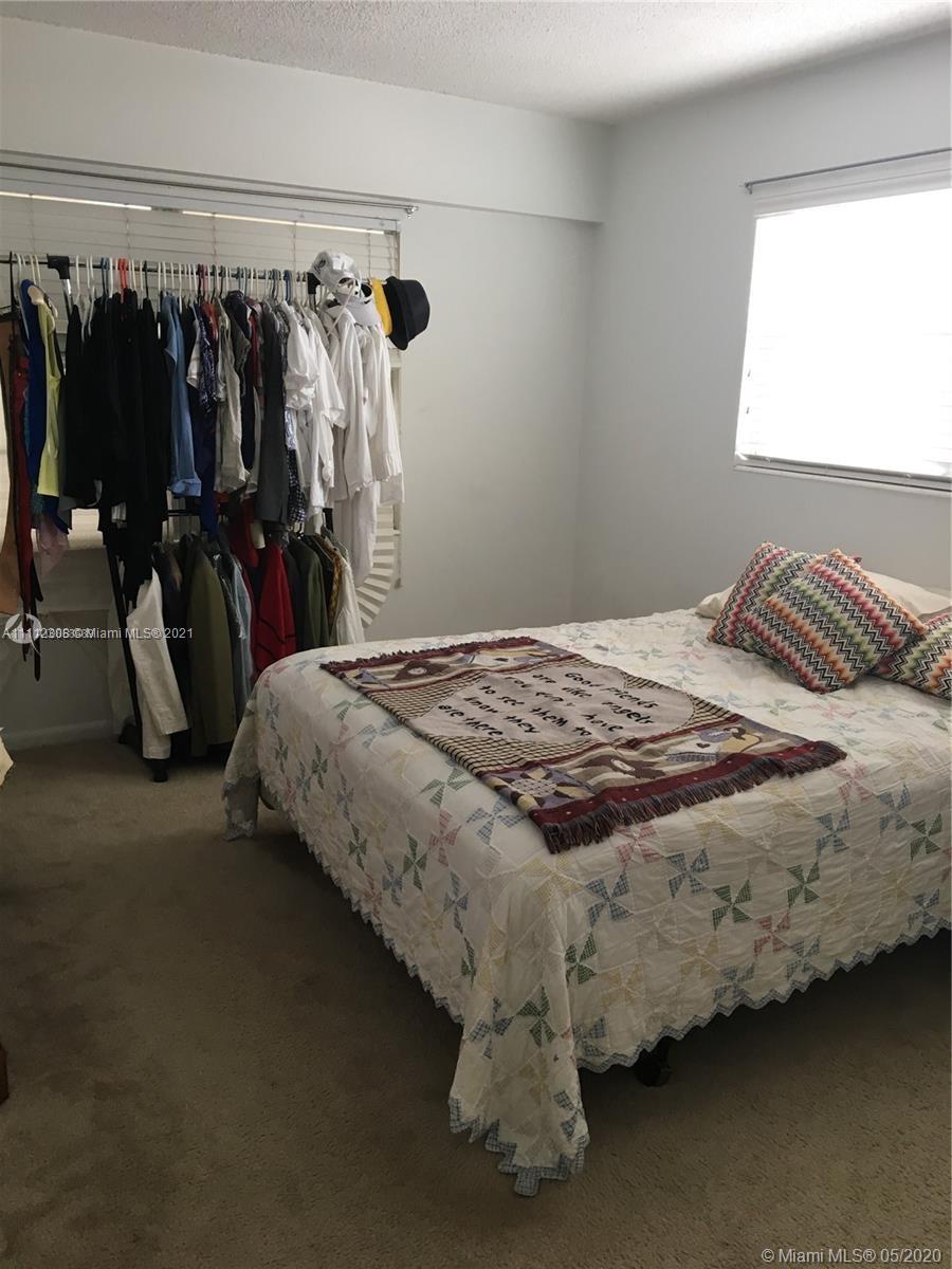 252 Fanshaw F, Unit 252F Boca Raton, FL 33434 - Photo 4 of 8 a bed sitting in a bedroom next to a window