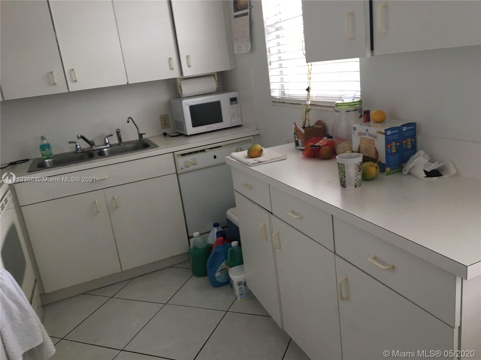 252 Fanshaw F, Unit 252F Boca Raton, FL 33434 - Photo 8 of 8 a kitchen with cabinets a window and appliances