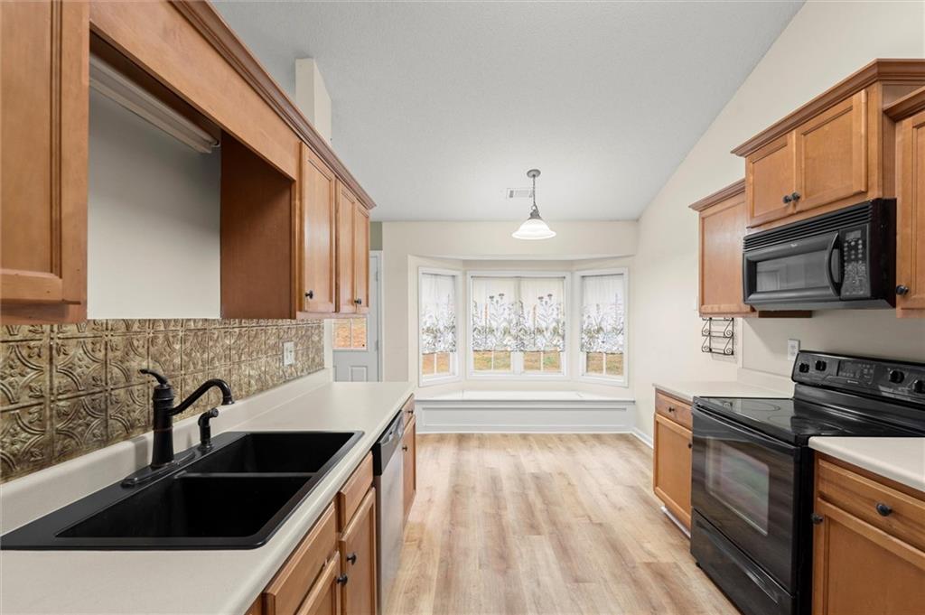 923 Downing Drive Bethlehem, GA 30620 - Photo 11 of 39 a kitchen with granite countertop a sink a counter space appliances and cabinets