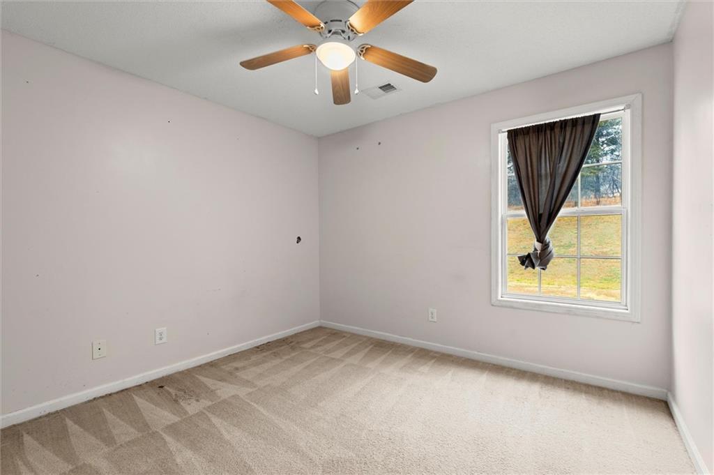 923 Downing Drive Bethlehem, GA 30620 - Photo 17 of 39 an empty room with window and a ceiling fan