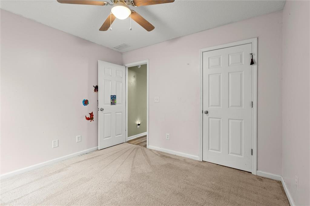 923 Downing Drive Bethlehem, GA 30620 - Photo 18 of 39 an empty room with closet and a chandelier fan