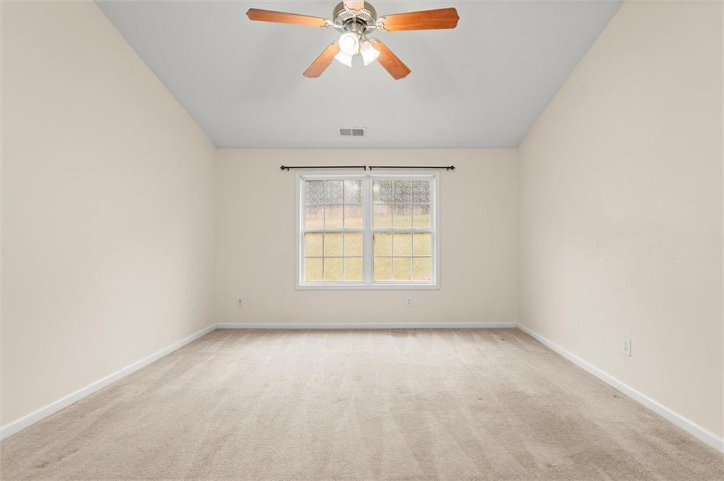 923 Downing Drive Bethlehem, GA 30620 - Photo 22 of 39 an empty room with a window and a chandelier fan
