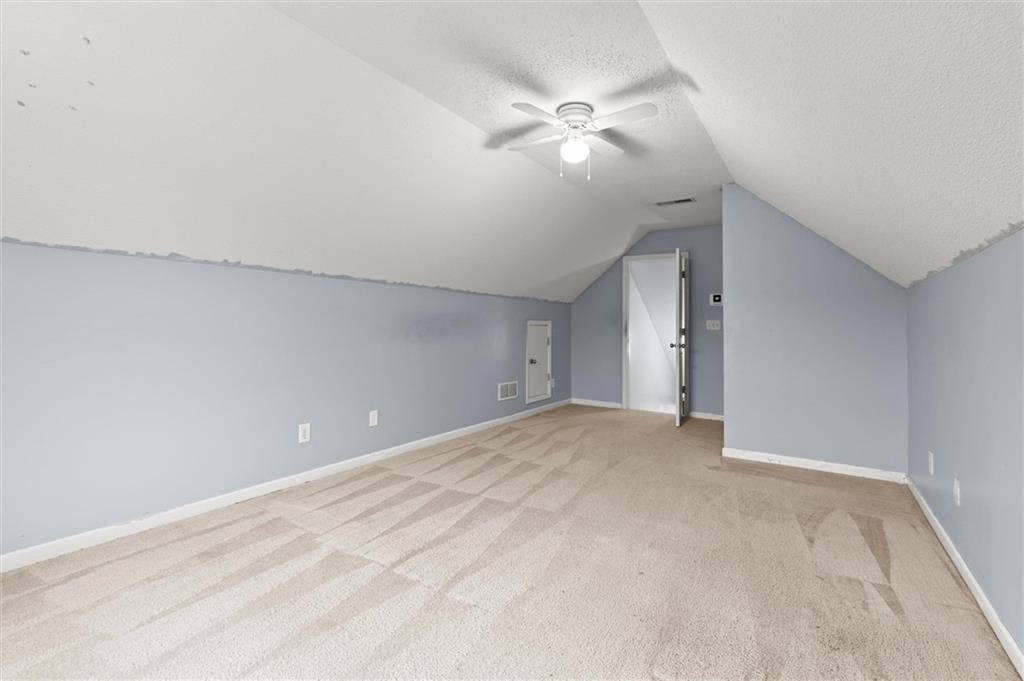923 Downing Drive Bethlehem, GA 30620 - Photo 28 of 39 a view of an empty room with a chandelier fan