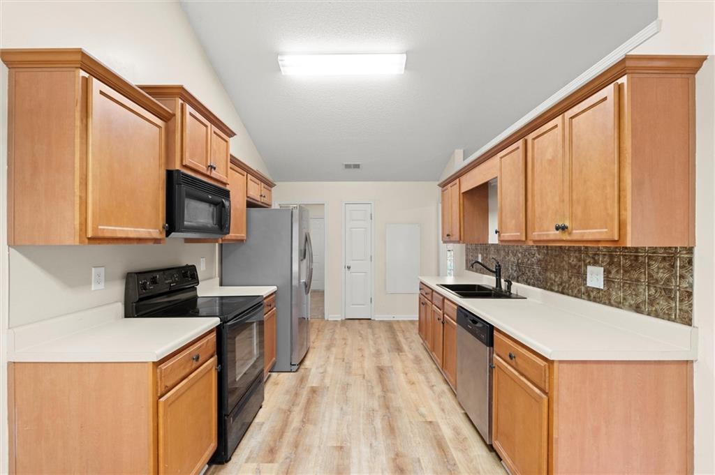 923 Downing Drive Bethlehem, GA 30620 - Photo 8 of 39 a kitchen with stainless steel appliances granite countertop a sink stove and refrigerator