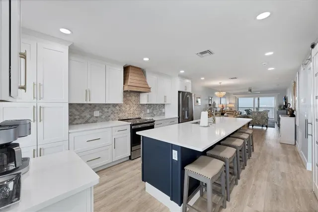 a kitchen with a sink appliances and cabinets
