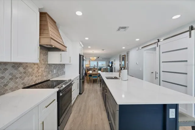 a large kitchen with a large counter top appliances and cabinets