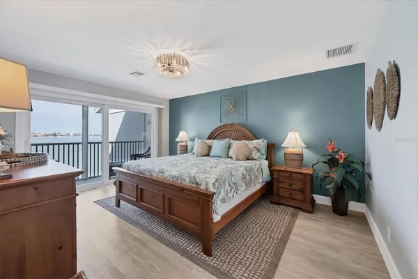 a bedroom with a bed and a chandelier