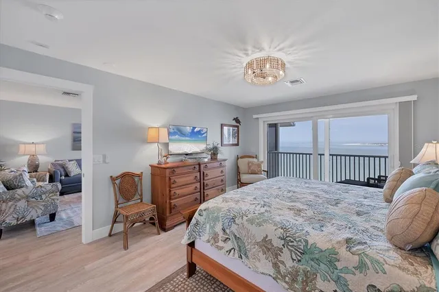 a bedroom with a bed a table and a dresser