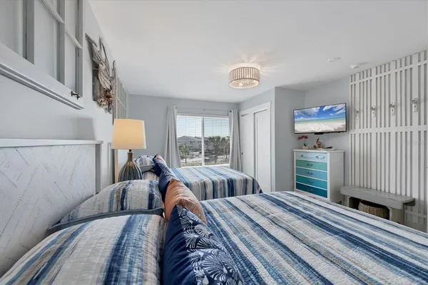 a bed sitting in a bedroom next to a window