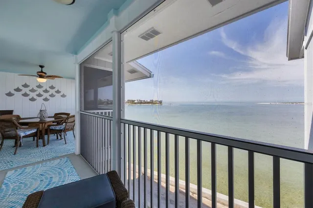 a view of a hallway to a livingroom with furniture