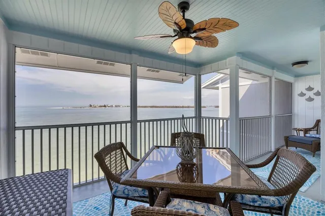 a view of a chairs and table in the balcony