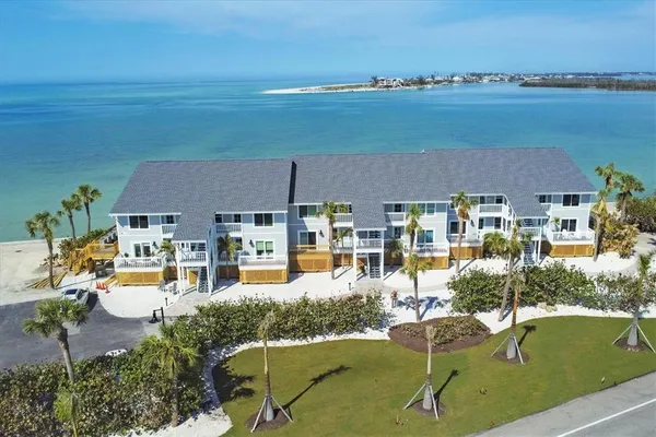 an aerial view of a house with outdoor space swimming pool and ocean view
