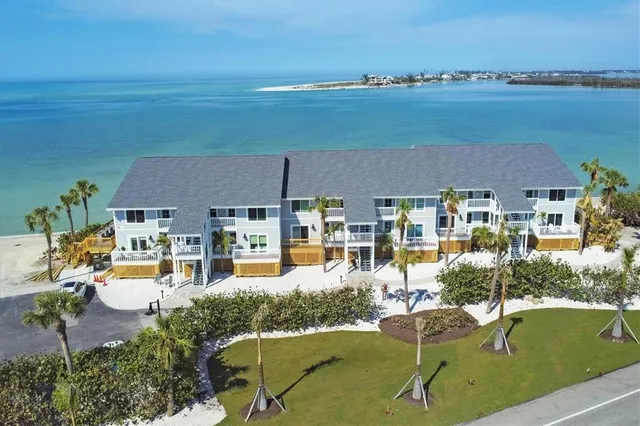 an aerial view of a house with outdoor space swimming pool and ocean view