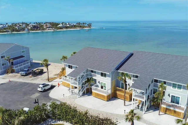 an aerial view of a house with ocean view